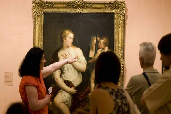 Museos gratis de Madrid - Guía turística hace una parada para explicar parte de la obra de un artista renacentista
