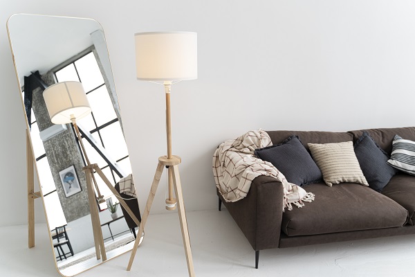 espejos decorativos - Habitación moderna decorada con un espejo decorativo, lámpara y sofá